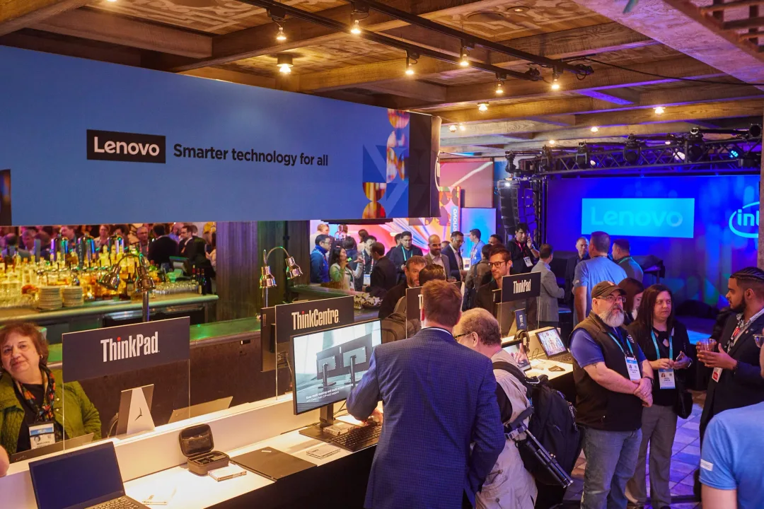 Lenovo exhibition booth at CES 2024 showcasing ThinkPad, ThinkCentre, and AI-powered business technology.
