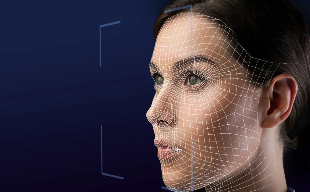 Black and white image of a woman's face in profile with a digital wireframe overlay, symbolizing facial recognition technology. The tone is technological and futuristic.